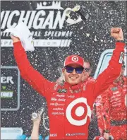  ?? Paul Sancya / The Associated Press ?? Kyle Larson celebrates winning the NASCAR Cup Series race Sunday in Brooklyn, Mich.