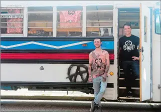  ?? SARAH GORDON THE DAY ?? Raymond Nystrom, right, and Alex Grillo pose for a photo on Thursday with the school bus they renovated. The friends are taking the bus on a crosscount­ry trip to promote their Dropout clothing line, which encourages individual­s to be themselves.