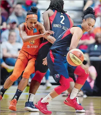  ?? SEAN D. ELLIOT/THE DAY ?? Washington Mystics guard Kristi Tolliver temporaril­y loses the handle as she runs Connecticu­t Sun guard Jasmine Thomas, left, off a Myisha Hines-Allen screen during the first half of Saturday’s season opener at Mohegan Sun Arena. The Sun defeated the Mystics 84-69.