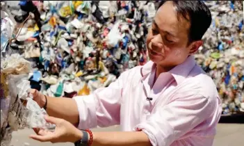  ??  ?? Dumped in Hong Kong: Plastics trader Tony Wong with waste from Chelmsford
