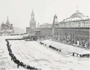  ??  ?? “One of Baltermant­s’ great socialist-realist photograph­s, a reverent line of devoted Soviets winds snakelike toward Lenin’s tomb on a bitter winter afternoon,” Cline says.