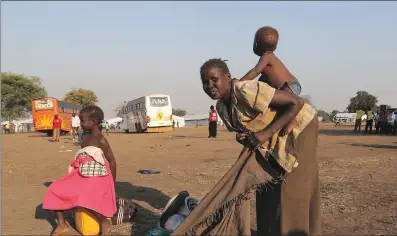  ?? PICTURE: REUTERS ?? A refugee mother from South Sudan prepares to carry her child on her back on arrival at Bidi Bidi refugee’s resettleme­nt camp near the border with South Sudan, in Yumbe district, northern Uganda, this month. The writer asks readers to spare a thought...