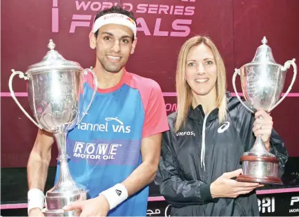  ??  ?? Mohamed Elshorbagy and Laura Massaro with their trophies after winning the men's and women's titles respective­ly in the PSA Dubai World Series Finals. (AN photo)