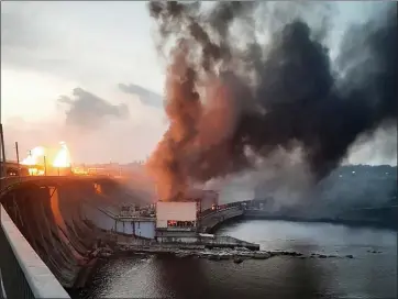  ?? TELEGRAM CHANNEL OF UKRAINE’S PRIME MINISTER DENYS SHMYHAL VIA AP ?? In this photo provided by Telegram Channel of Ukraine’s Prime Minister Denys Shmyhal, smoke and fire rise over the Dnipro hydroelect­ric power plant after Russian attacks in Dnipro, Ukraine, on Friday.