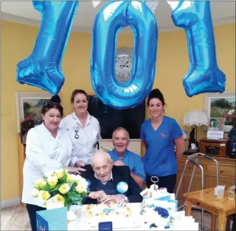  ??  ?? Patrick Kelly celebratin­g his 101st birthday with staff from New Ross Community Hospital.