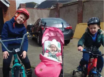  ??  ?? Byrne (9) pictured with his baby sister Cara (9 months) and his younger brother Harry (4).