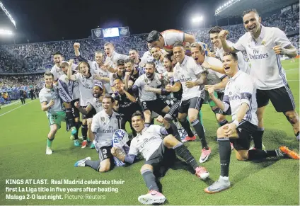  ?? Picture: Reuters ?? KINGS AT LAST. Real Madrid celebrate their first La Liga title in five years after beating Malaga 2-0 last night.