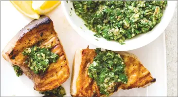  ?? Associated Press photo ?? This undated photo provided by America’s Test Kitchen shows grilled swordfish steaks with salsa verde in Brookline, Mass.