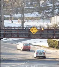  ?? H John Voorhees III / Hearst Connecticu­t Media ?? Interest is growing in the Connecticu­t legislatur­e to reopening the old commuter rail line from Danbury to Southeast, N.Y., to create a shortcut to Manhattan for Danbury commuters. Vehicles travel West Street on Thursday under the old train line.