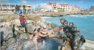  ?? AP PHOTO ?? A human chain of residents passing supplies provided by a dutch soldier after the passing of Hurricane Irma in Dutch Caribbean St. Maarten.