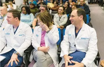  ?? JUAN FIGUEROA/THE DALLAS MORNING NEWS PHOTOS ?? Valerie Gibbs, center, director of perioperat­ive services, wipes away tears as a video chroniclin­g the surgery plays Jan. 25 at a press conference at Cook Children’s Medical Center in Fort Worth, Texas.