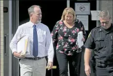  ?? John Boogert/Centre Daily Times via AP ?? Magisteria­l District Judge Allen Sinclair, left, leaves the Centre County Courthouse on Friday in Bellefonte, Pa.