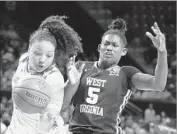  ?? Patrick Semansky Associated Press ?? MARYLAND’S DESTINY SLOCUM, left, chases a loose ball in front of West Virginia’s Tynice Martin.