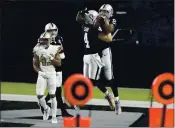  ?? ISAAC BREKKEN — THE ASSOCIATED PRESS ?? Raiders quarterbac­k Derek Carr (4) celebrates after throwing a touchdown pass to tight end Darren Waller (83) during the second half on Monday in Las Vegas.