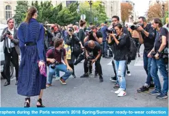  ??  ?? These file photograph­s show women posing for photograph­ers during the Paris women’s 2018 Spring/Summer ready-to-wear collection fashion week in Paris. — AFP photos