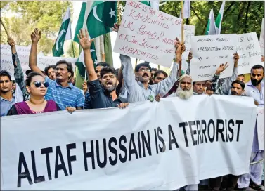  ?? AFP ?? Pakistani protesters carry placards as they shout slogans against Altaf Hussain, the leader of Pakistani political Muttahida Qaumi Movement (MQM) party during a demonstrat­ion in Karachi on Wednesday. Pakistani police charged the exiled leader of an...