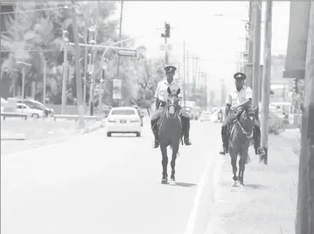  ??  ?? Morning canter:
Mounted officers of the Guyana Police Force cantering along Thomas Lands yesterday morning.