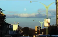  ??  ?? The picture taken on Wednesday from a view point along Leopold Takawira Street shows a full moon before the sun sets. At full moon, the moon and sun are on a line, with Earth in-between. It’s as though Earth is the fulcrum of a seesaw, and the moon and...