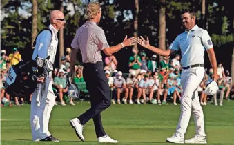  ?? ROB SCHUMACHER/ ARIZONA REPUBLIC ?? Will Zalatoris and Corey Conners greet each other on the 18th green during the final round of The Masters.