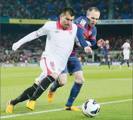  ??  ?? FC Barcelona’s Andres Iniesta (right), duels for the ball with Sevilla’s Gary Medel during a Spanish La Liga soccer match at the Camp Nou Stadium in
Barcelona, Spain, Feb 23. (AP)