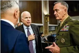  ?? ANDREW HARNIK / ASSOCIATED PRESS ?? Defense Secretary Jim Mattis (left), and Joint Chiefs Chairman Gen. Joseph Dunford (right) speak Tuesday with Sen. John McCain, R-Ariz., as they arrive to testify on Afghanista­n before the Senate Armed Services Committee in Washington.