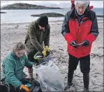  ??  ?? Marine environmen­talist Janie Steele and volunteers filled buckets and bags of rubbish from Wee Ganavan.