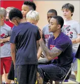  ?? DAVID JABLONSKI / STAFF ?? Kyle Davis works with children during a basketball camp at UD’s Cronin Center this week. Davis and Scoochie Smith were the only Flyers to play in all 33 games last season. He’s played in all but two games at UD.