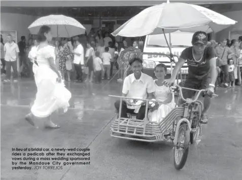  ??  ?? In lieu of a bridal car, a newly-wed couple rides a pedicab after they exchanged vows during a mass wedding sponsored by the Mandaue City government yesterday. JOY TORREJOS