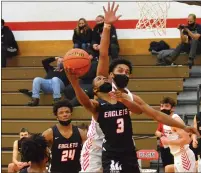  ??  ?? Orchard Lake St. Mary’s Kareem Rozier (3) goes in for a layup in front of a Grand Blanc defender in the fourth quarter of a 65-52 win on Wednesday.