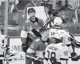  ?? DAVID SANTIAGO dsantiago@miamiheral­d.com ?? Panthers forward Jonathan Huberdeau (11) scraps with Tampa Bay’s David Savard during the first playoff series between the cross-state rivals last May.