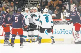  ?? Brooke LaValley / Columbus Dispatch ?? The Sharks celebrate after Marc-Edouard Vlasic’s third-period goal. Vlasic beat Columbus goalie Sergei Bobrovsky with a backhand.