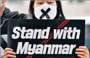  ?? AP ?? A member of a youth group holds a sign during a rally against the coup near the Myanmar embassy in Seoul, South Korea.