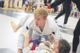  ?? FRAM DINSHAW/TRURO NEWS ?? Haligonian Neil Mcdonald, top, grappled with Marmac Athletics’ Connor Mackenzie. Mcdonald went on to beat Mackenzie and earn bronze in the under-145 lb category at the Rogue Grappling 7 – Out Cold competitio­n on Jan. 18.