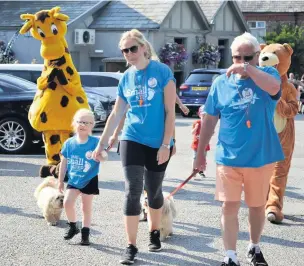  ??  ?? ●●Bella Williams (left) crossing the finish line with PeeWee the giraffe, Vicki Almond and Doug Almond