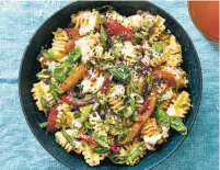  ?? JULIA GARTLAND/NEW YORK TIMES ?? Sweet peppers are cooked down with whole garlic cloves in this vegetable-rich pasta with anchovies and ricotta.