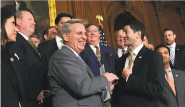  ?? Susan Walsh / Associated Press ?? Reps. Kevin McCarthy (front, left) and Paul Ryan celebrate the bill’s passage with fellow Republican­s.