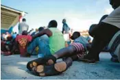  ?? RAMON ESPINOSA/AP ?? Haitians wait to be processed and receive medical attention at a tourist campground in Sierra Morena, in the Villa Clara province of Cuba, on Wednesday.