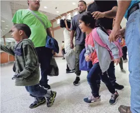  ?? ERIC GAY/AP ?? Asylum seekers from Honduras and Guatemala arrive at a bus station June 21 after they were processed and released in McAllen, Texas.