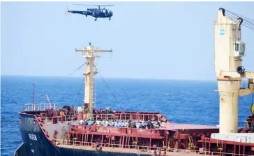  ?? INDIAN NAVY X VIA AGENCE FRANCE-PRESSE MV Ruen. ?? HELICOPTER of India’s Navy flies near the recaptured Maltese ship