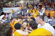  ?? MARK WALLHEISER — THE ASSOCIATED PRESS ?? Tennessee players swarm guard Lamonte Turner, center, after he hit the game-winning shot at the buzzer against Virginia Commonweal­th Saturday. Tennessee won, 72-69.