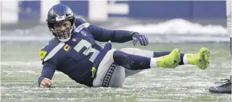  ?? THE ASSOCIATED PRESS ?? Seattle Seahawks quarterbac­k Russell Wilson starts to right himself after being knocked to the turf during the second half of the Seahawks game Sunday against against the Chicago Bears. Seattle lost the game 25-24, ensuring a last-place finish in their division.