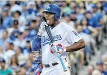  ?? Robert Gauthier Los Angeles Times ?? YASIEL PUIG of the Dodgers has been animated during the postseason, including treating his bat like a lollipop.
