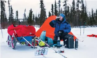  ??  ?? BELOW Jennifer Stronge gets ready to hit the road after camping out nearby Midway Lake on the Dempster Highway