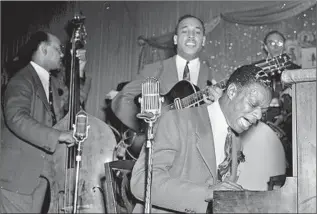  ?? Los Angeles Public Library ?? NAT KING COLE performs at an L.A. club. Known as “Brown Broadway,” Central Avenue attracted Black celebritie­s beyond the musical world, including Langston Hughes and Joe Louis.