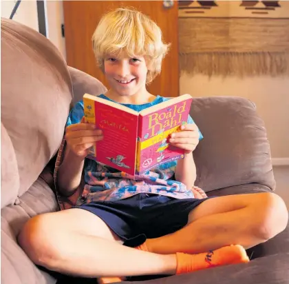  ?? Photo / Peter Meecham ?? Hamish Firth, 9, from Pakuranga, is one youngster who loves to get his nose in a book.