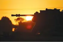  ?? REUTERS ?? AN ARMORED personnel carrier (APC) is seen silhouette­d as the sun sets, amid the conflict between Israel and the Palestinia­n Islamist group Hamas, near the IsraelGaza border, in Southern Israel, Dec. 25.