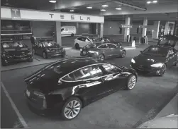  ?? TRIBUNE NEWS SERVICE ?? New Tesla vehicles available for sale are pictured in the parking garage of the Westfield Topanga shopping center in Canoga Park.