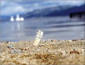  ?? AMANDA SHORT/Special to The Herald ?? After local Girl Guides collected more than 600 cigarette butts on Skaha Beach in one afternoon, the city is cracking down on smoking in public places.