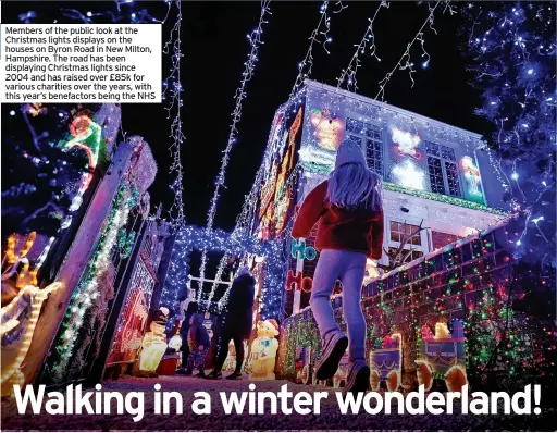  ?? ?? Members of the public look at the Christmas lights displays on the houses on Byron Road in New Milton, Hampshire. The road has been displaying Christmas lights since 2004 and has raised over £85k for various charities over the years, with this year’s benefactor­s being the NHS