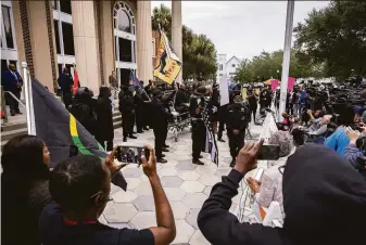  ?? Stephen B. Morton / Associated Press ?? Dozens of Black Lives Matter protesters gather outside the Glynn County Courthouse in Brunswick, Ga., where the trial over the killing of Ahmaud Arbery is being held.